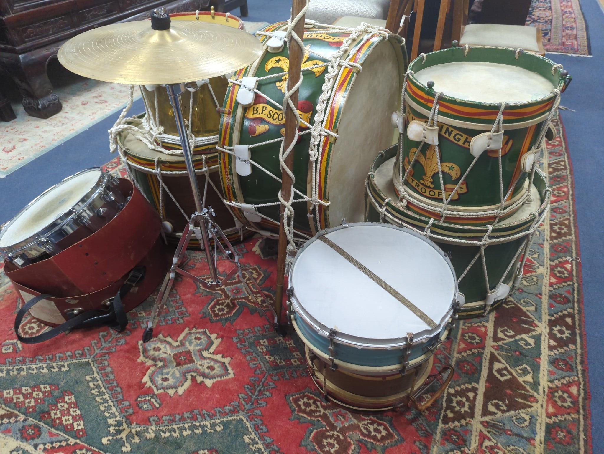 A collection of painted wood drums from Warningham troop, probably ex. military, together with leather straps sheet music pouches, a pre 1947 leopard skin for the bass drum (lined), drum major's jacket and staff, cymbals